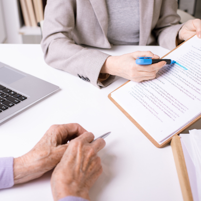 hands of insurance agent underlining important phr AKNNXHT 1 1